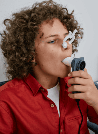 A person is breathing into a spirometer